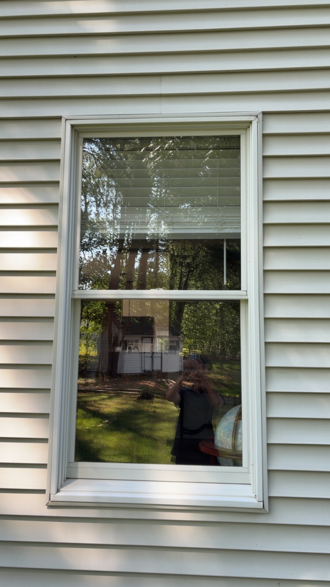 After window cleaning by H&H Window Cleaning — spotless sills and frames with streak-free, crystal clear glass reflecting the yard